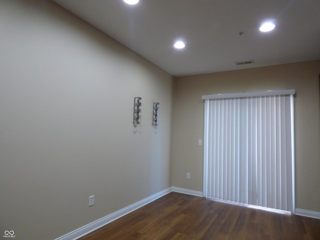 unfurnished room featuring dark wood-type flooring