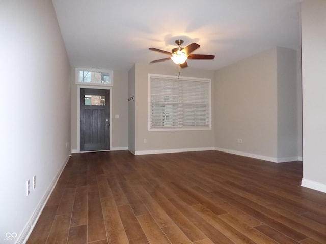 foyer entrance featuring ceiling fan and dark wood-type flooring