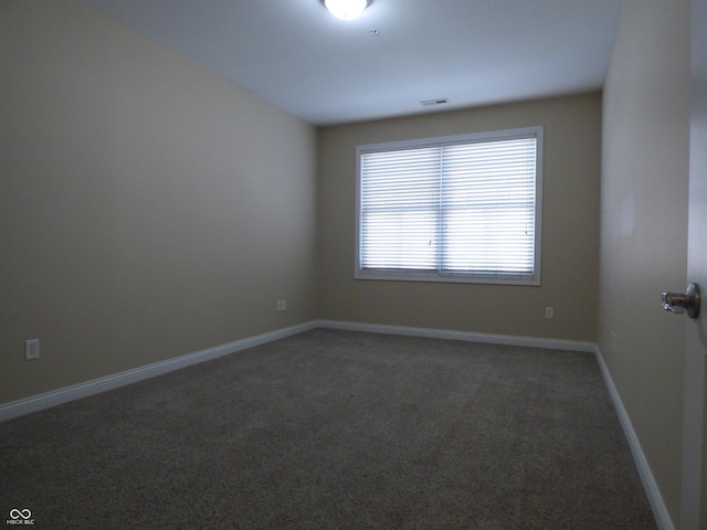 empty room featuring dark carpet