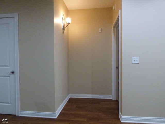 hallway with dark hardwood / wood-style flooring