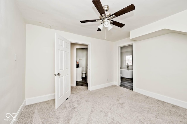 unfurnished bedroom featuring light carpet and ceiling fan