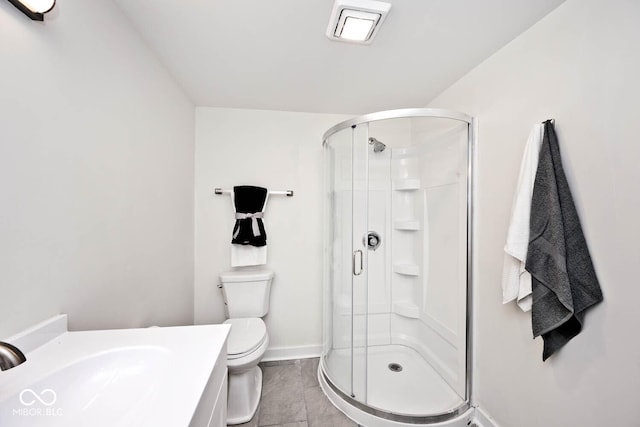 bathroom featuring sink, a shower with shower door, and toilet