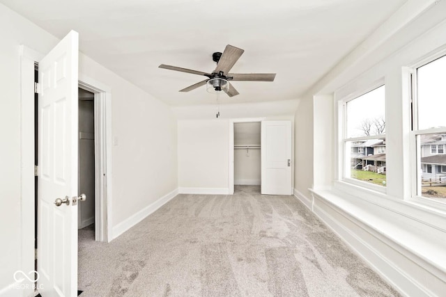 unfurnished bedroom with ceiling fan, a closet, and light colored carpet