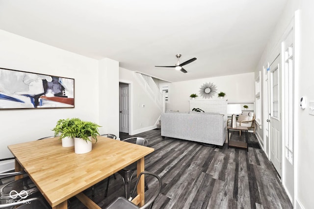 living room with dark hardwood / wood-style floors and ceiling fan