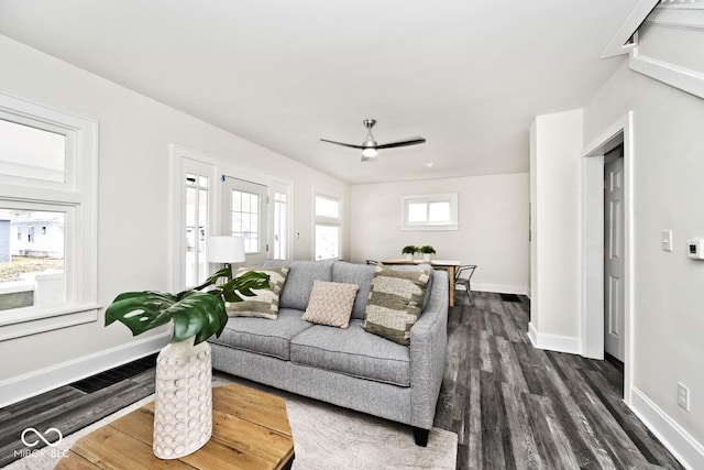 living room with ceiling fan and dark hardwood / wood-style flooring