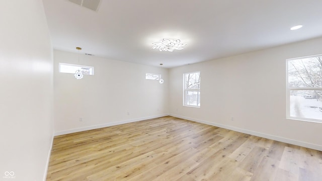 empty room with light hardwood / wood-style flooring