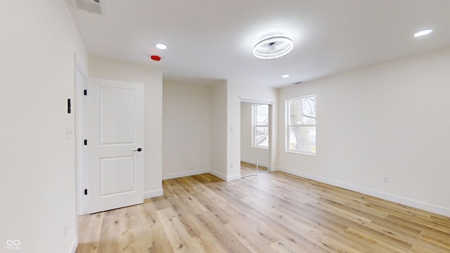 unfurnished room with light wood-type flooring