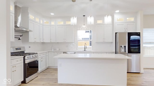 kitchen featuring sink, a center island, white cabinetry, and appliances with stainless steel finishes