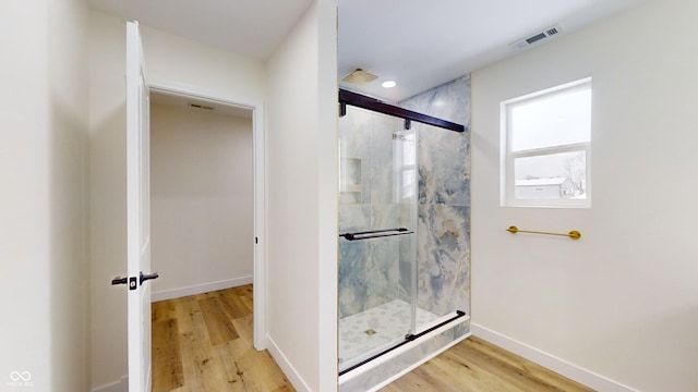 bathroom featuring an enclosed shower and hardwood / wood-style floors