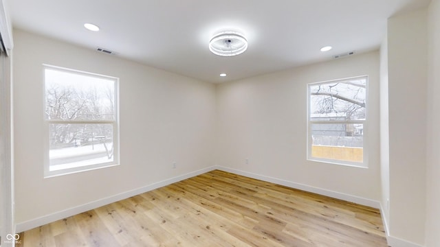 unfurnished room featuring light hardwood / wood-style floors