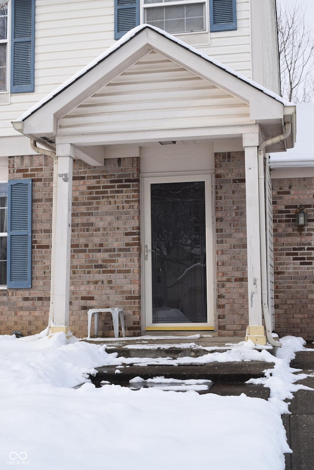 view of snow covered property entrance