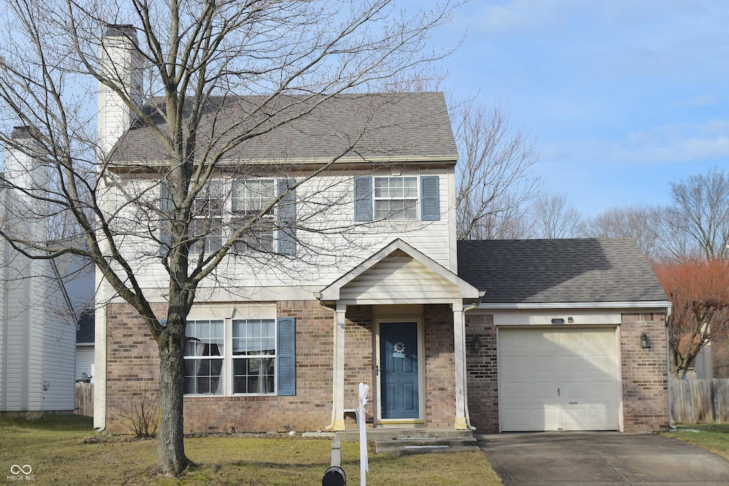 504 Grand Woods Dr, Indianapolis, IN 46224 - view of front of house with a garage and a front lawn