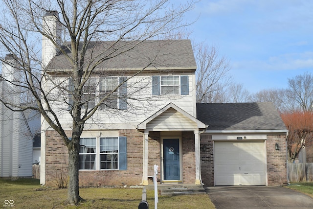 view of front of house with a garage and a front lawn