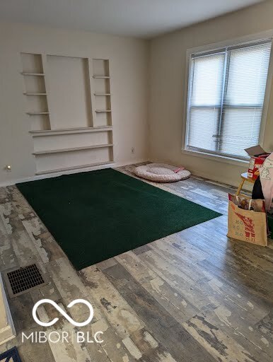 unfurnished living room with hardwood / wood-style flooring