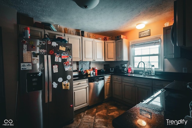 kitchen featuring sink, stainless steel appliances, and a textured ceiling