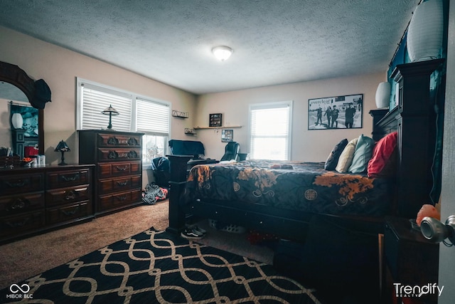 carpeted bedroom featuring multiple windows and a textured ceiling