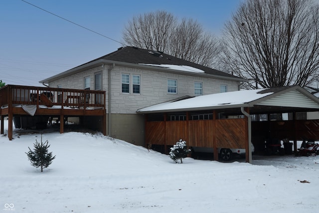 snow covered property with a deck