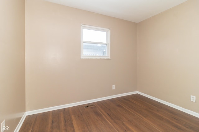 unfurnished room with dark hardwood / wood-style floors