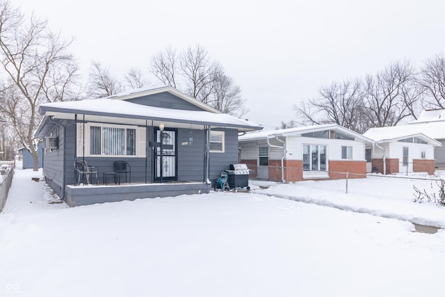 snow covered house with covered porch