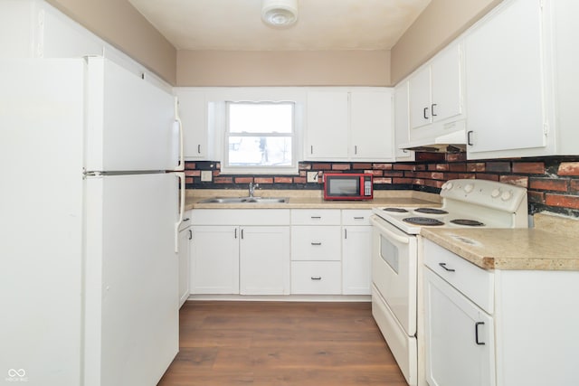 kitchen with dark hardwood / wood-style floors, sink, white cabinets, and white appliances