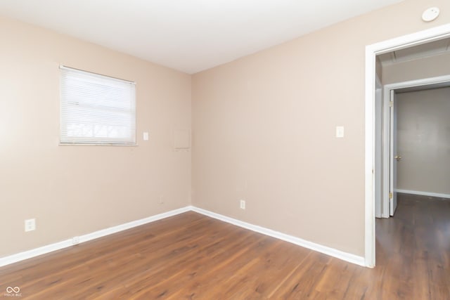 empty room featuring dark wood-type flooring