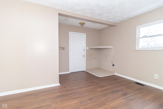 empty room featuring dark hardwood / wood-style floors