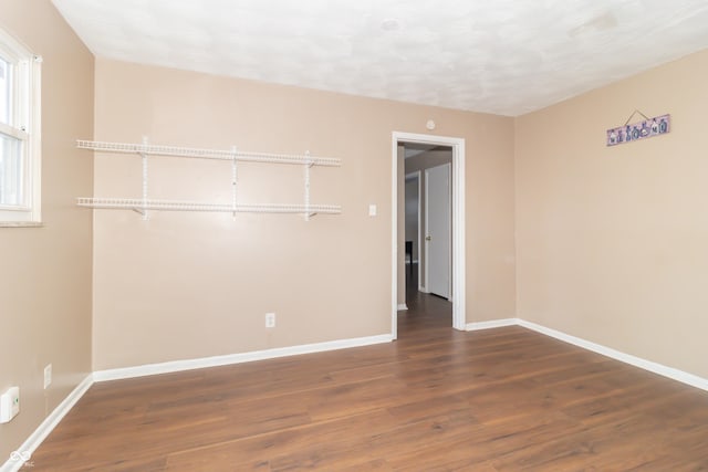 spare room with dark hardwood / wood-style floors