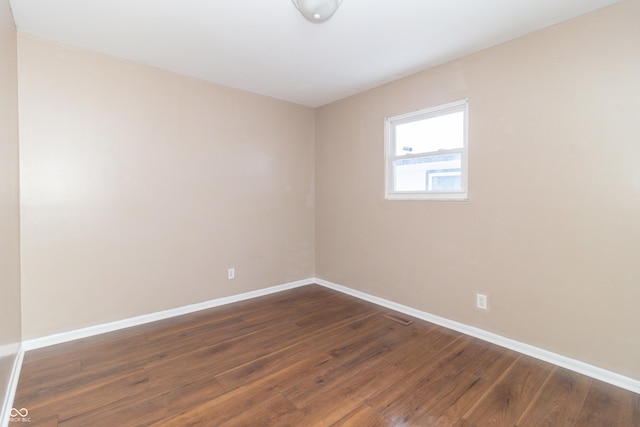 empty room with dark wood-type flooring