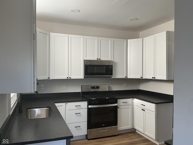 kitchen with white cabinetry, sink, and appliances with stainless steel finishes