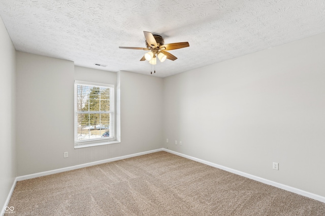 carpeted spare room with a textured ceiling and ceiling fan