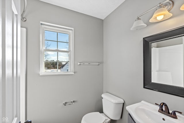 bathroom with sink, toilet, and a textured ceiling