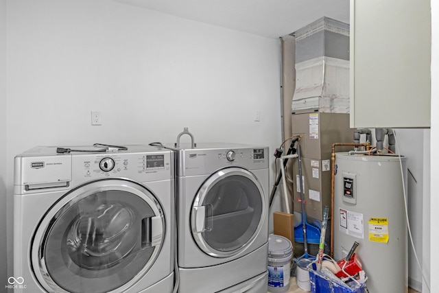 washroom with electric water heater and washing machine and dryer