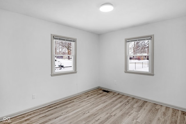 unfurnished room with light hardwood / wood-style floors