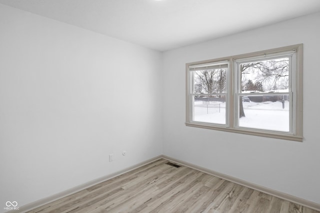 unfurnished room with light wood-type flooring