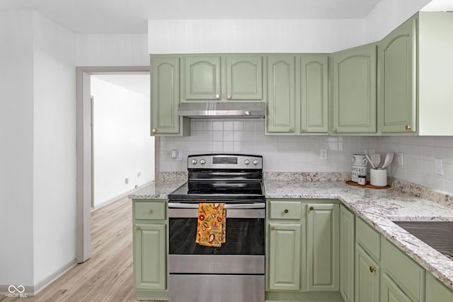 kitchen with electric stove, decorative backsplash, green cabinets, and light stone counters