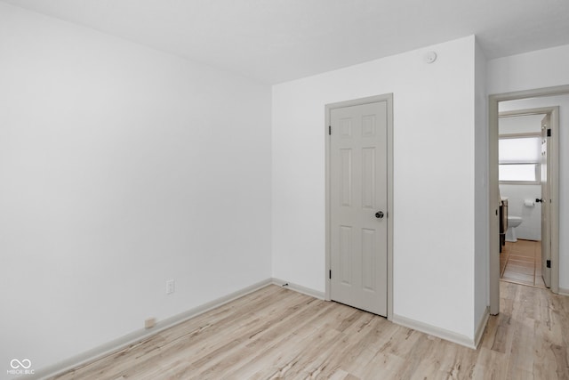 spare room with light hardwood / wood-style floors