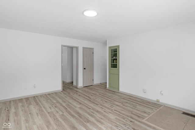 spare room with light wood-type flooring