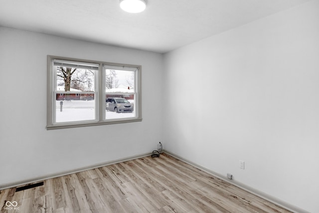 spare room featuring light hardwood / wood-style floors