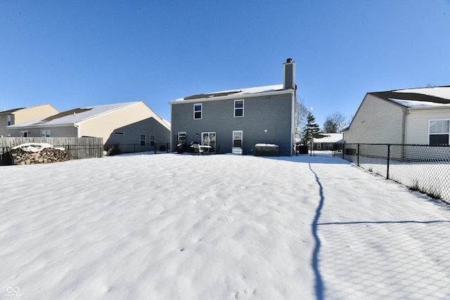 view of snow covered back of property