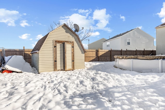 yard layered in snow with a shed