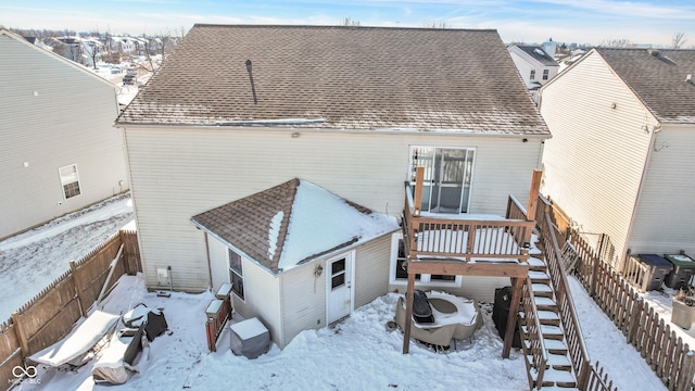 view of snow covered rear of property