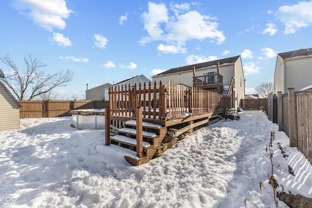 snow covered property featuring a wooden deck