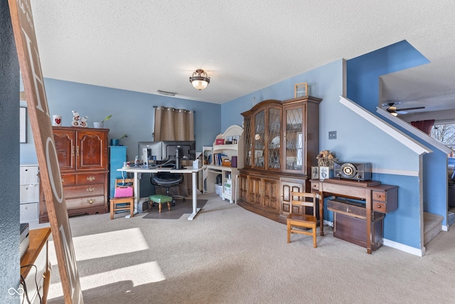 office area with ceiling fan, carpet floors, and a textured ceiling