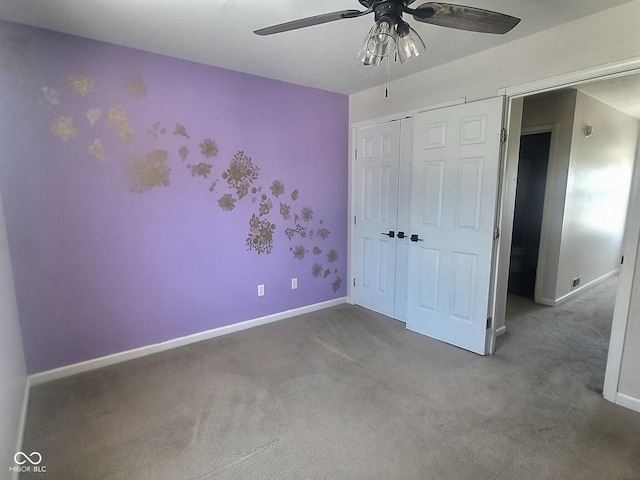 unfurnished bedroom featuring carpet floors, a closet, and ceiling fan