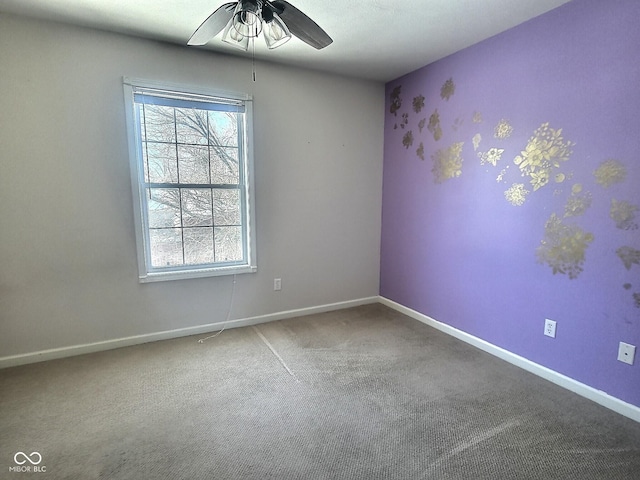 unfurnished room with ceiling fan and carpet flooring