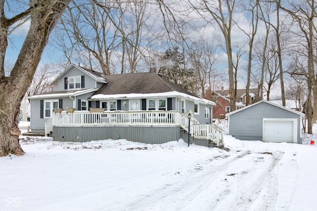 view of front facade with a garage, a deck, and an outbuilding