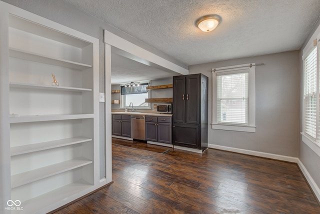 kitchen with dark wood-type flooring, built in features, appliances with stainless steel finishes, and a wealth of natural light