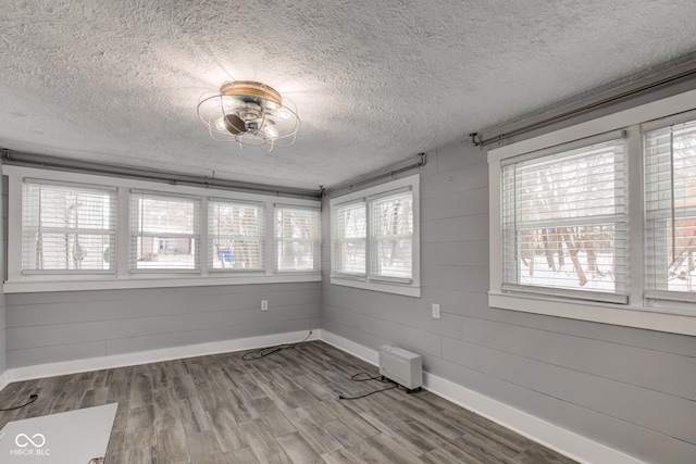 unfurnished sunroom featuring plenty of natural light