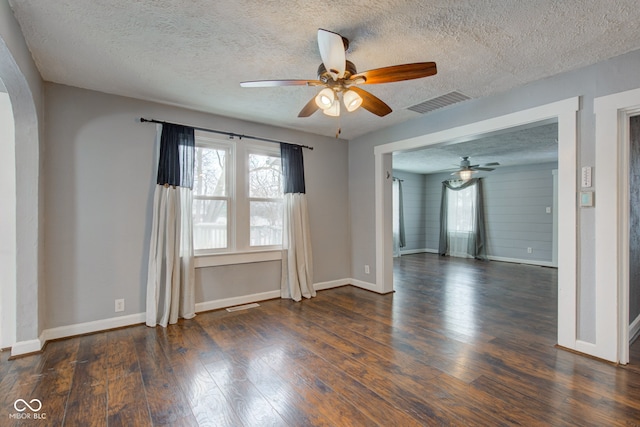 unfurnished room with dark wood-type flooring, a textured ceiling, and ceiling fan