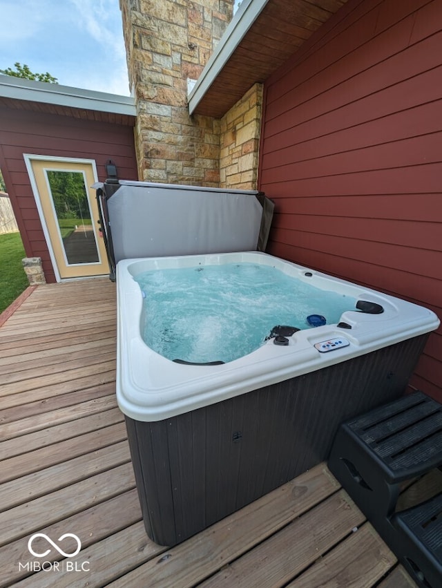 wooden terrace with a hot tub